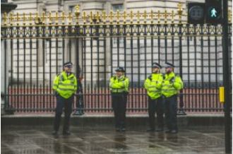 Police in London turned in their guns after an officer was charged with murder.