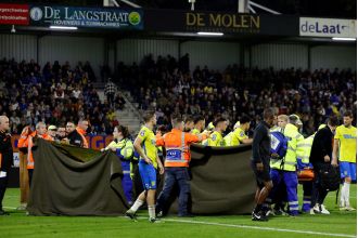 Goalkeeper Vaessen is conscious in hospital after a collision that caused the Ajax-RKC Waalwijk match to be abandoned.