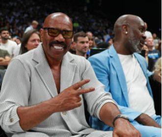 Michael B. Jordan and Steve Harvey embraced at an NBA game, a year after Michael's breakup with Lori Harvey.