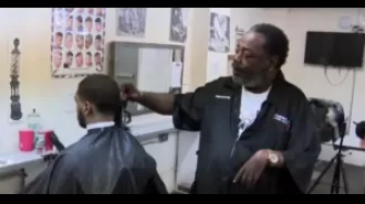 60-year-old black barber with only one functioning arm inspiring others with his resilience and determination.