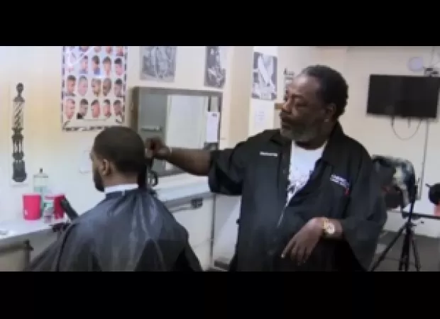 60-year-old black barber with only one functioning arm inspiring others with his resilience and determination.