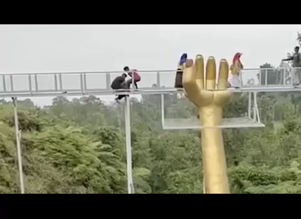 Tourist dies after walking on 30ft-high glass walkway which suddenly shatters.