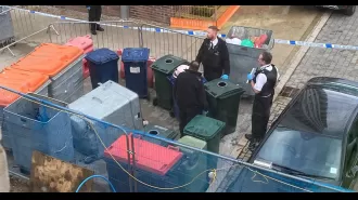 Body of woman discovered in large plastic container with wheels.