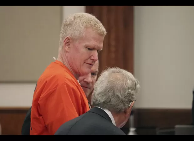 Ex-lawyer gets plea deal for 101 financial crimes after murdering wife and son; smirks in court.