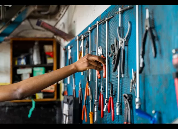 11-year-old black girl in Ghana repairs motorcycles as a mechanic.