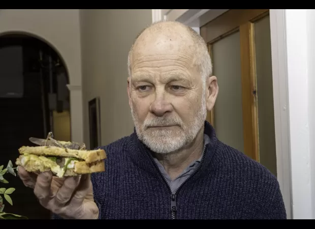Builder shocked after consuming a live locust from a store-bought salad.