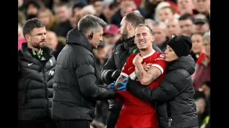 Kostas Tsimikas of Liverpool injured in accidental collision with manager Jurgen Klopp.