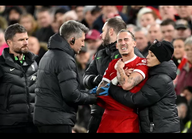 Kostas Tsimikas of Liverpool injured in accidental collision with manager Jurgen Klopp.