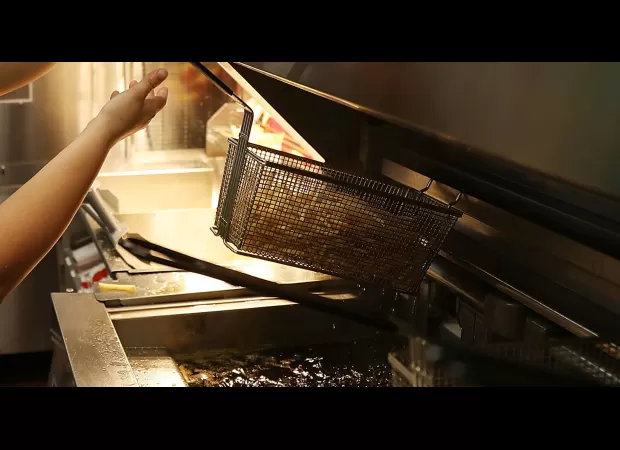 Pastor attempted to force McDonald's employee into deep fryer.