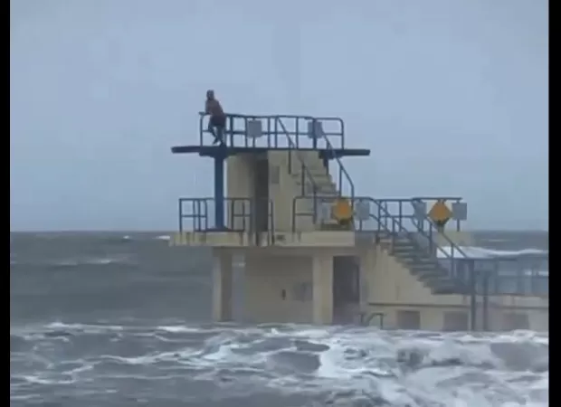 Despite being warned, a diver recklessly enters rough waters caused by Storm Isha.
