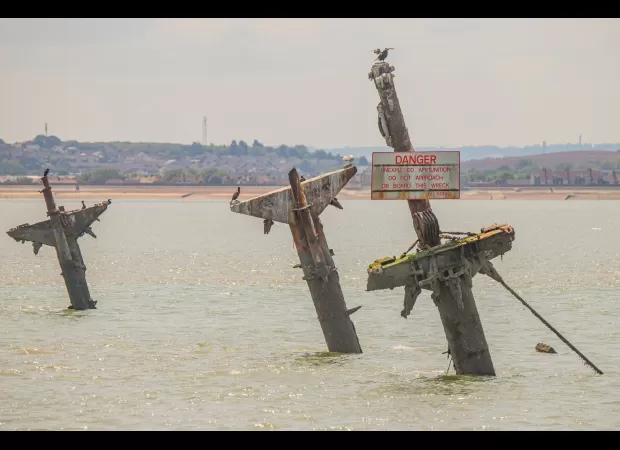 Experts warn that a ship loaded with explosives in the Thames is at risk of detonation.