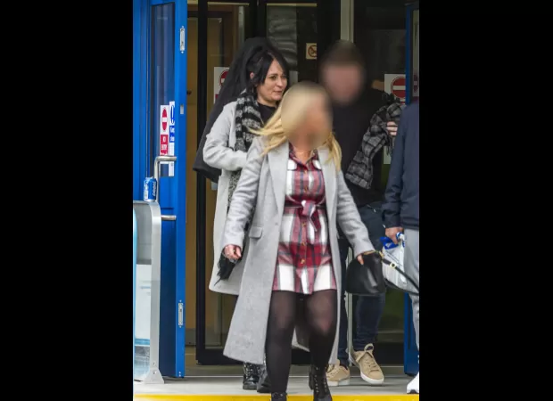 Two women fight in road rage incident, causing traffic to stop.