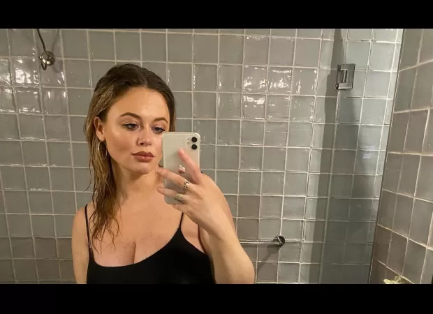 Actress Emily Atack posts rarely seen photos of her baby bump as she and her partner, who is also her step-cousin, are expecting a child.