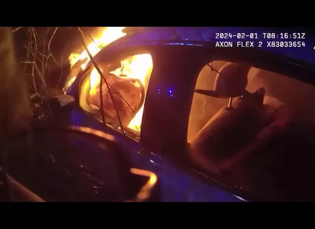Police heroically save man from burning car in dramatic rescue.