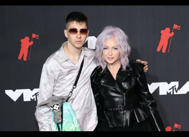 Singer Cyndi Lauper's son arrested for having gun after Harlem shooting.