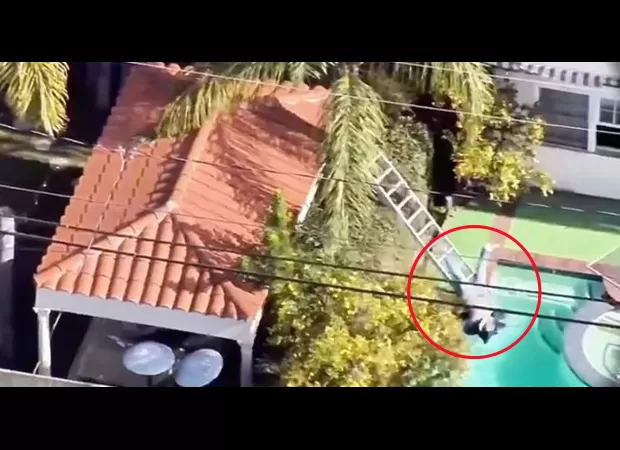 Burglar falls in pool while running from luxury home robbery.