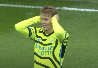 Arteta reaches out to Odegaard following his celebration during Arsenal's victory against Burnley.