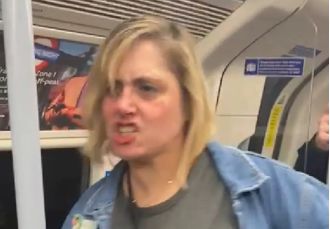 Woman angrily targets innocent person on train, demands they leave and makes racist comments.