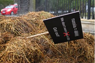 Someone placed a large pile of dung and a sign saying 