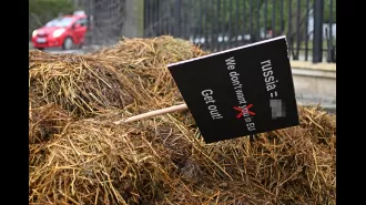 Someone placed a large pile of dung and a sign saying 