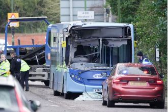 High winds cause tree to fall onto bus and van, injuring six individuals.