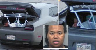Mother caught driving with son holding down baby bassinet in open car trunk.