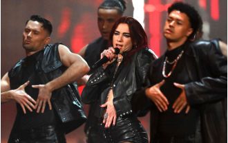 Dua Lipa's bold acrobatic performance starts off the Brit Awards in leather attire.