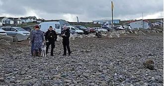 Dog walkers found unexploded bomb at beach, causing authorities to close off area.