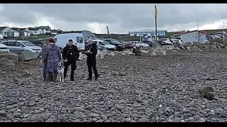 Dog walkers found unexploded bomb at beach, causing authorities to close off area.