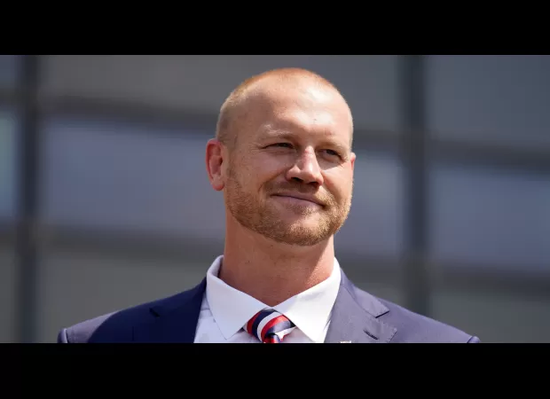 Former pro wrestler surrenders to police for alleged murder of man in hotel room.