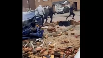A car containing schoolkids crashes into a wall, and the children run away.
