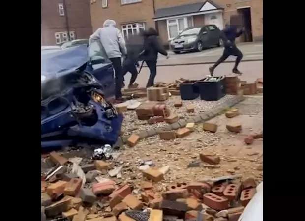 A car containing schoolkids crashes into a wall, and the children run away.