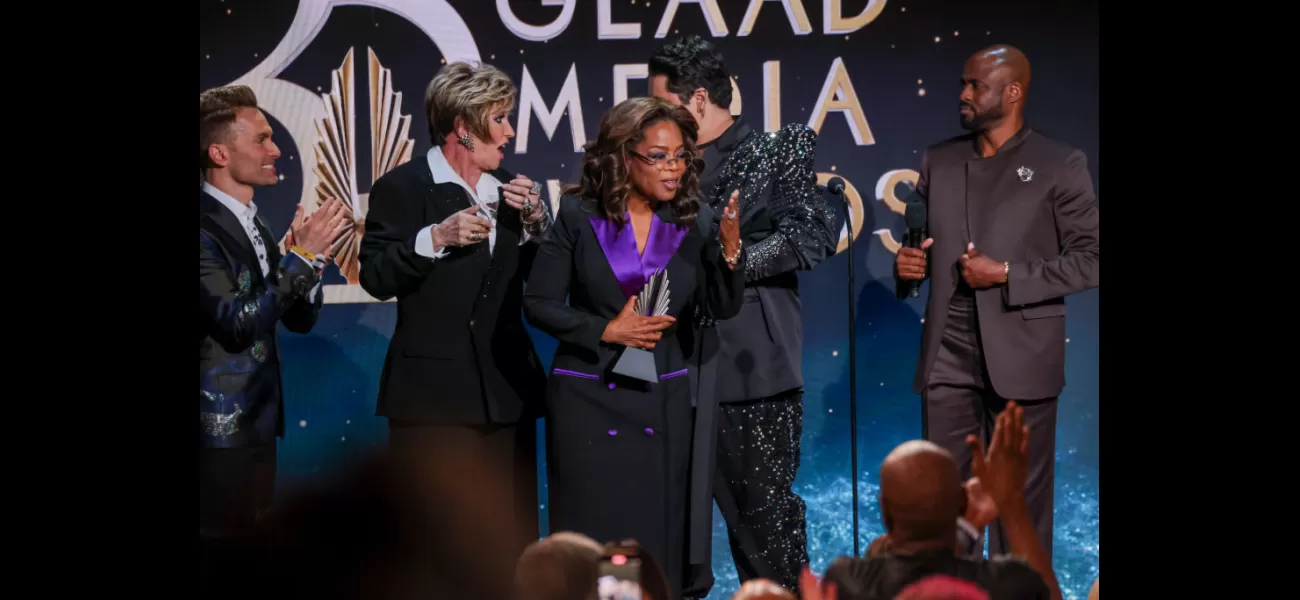 A chaotic moment as woman falls onstage while presenting Oprah Winfrey an award.