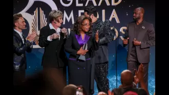 A chaotic moment as woman falls onstage while presenting Oprah Winfrey an award.