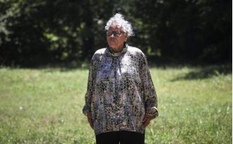 A woman buys back Texas property run out by mob long ago.