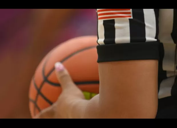 NCAA changes ref in game due to conflicting background.