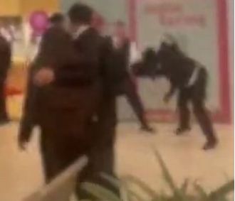 Chaotic scene as kids overrun mall, confront guards in loud, rowdy outburst.