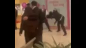 Chaotic scene as kids overrun mall, confront guards in loud, rowdy outburst.