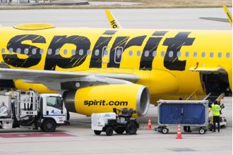 A female passenger caused a disturbance on a Spirit Airlines flight and shouted a racial slur at police officers.
