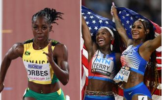 American runners help a hurt Jamaican sprinter at the USA vs. Jamaica track meet.