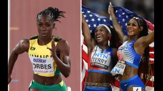 American runners help a hurt Jamaican sprinter at the USA vs. Jamaica track meet.