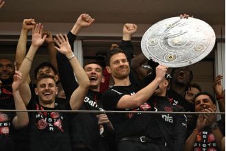 Xabi Alonso and former Arsenal leader Granit Xhaka celebrate Bayer Leverkusen's first Bundesliga win.
