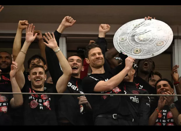 Xabi Alonso and former Arsenal leader Granit Xhaka celebrate Bayer Leverkusen's first Bundesliga win.