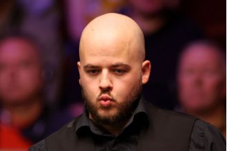 Defending champion Luca Brecel is defeated by Dave Gilbert in the World Snooker Championship first round.