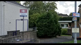 Woman was pushed onto train tracks at crowded station and suspect taken into custody for attempted murder.