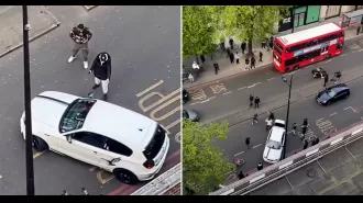 A London street brawl between two men wielding machetes is captured on video.