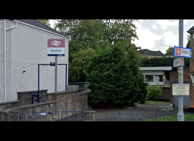 Woman was pushed onto train tracks at crowded station and suspect taken into custody for attempted murder.