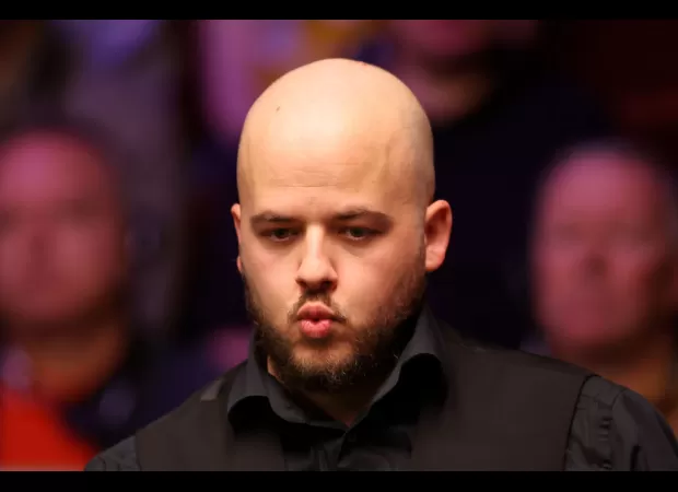Defending champion Luca Brecel is defeated by Dave Gilbert in the World Snooker Championship first round.
