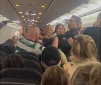 A Celtic fan assaulted police on a flight after drinking a bottle of vodka.