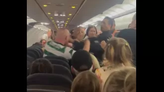 A Celtic fan assaulted police on a flight after drinking a bottle of vodka.